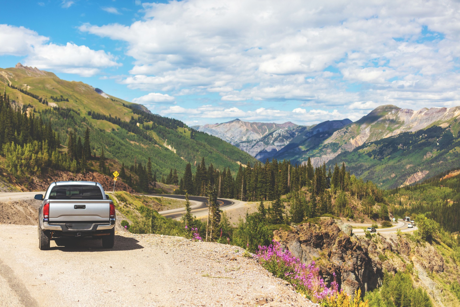 Pickup truck parked along paved highway on Western USA Road and in beautiful Mountain landscape overlooking Silverton Colorado